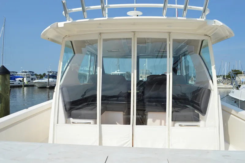 Slide: The Image of 2016 Tiara Yachts Q44 at marina, showcasing sleek design and spacious interior. - 41