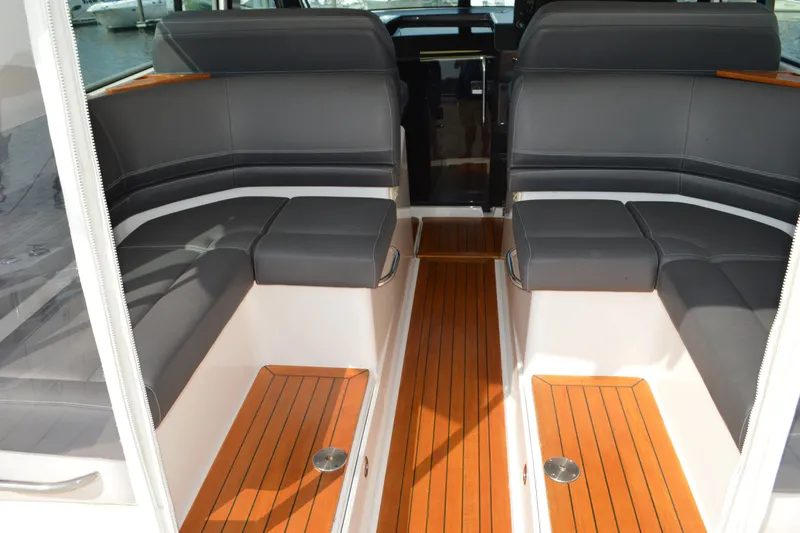 Slide: The Image of 2016 Tiara Yachts Q44 interior with sleek seating and wooden flooring. - 44