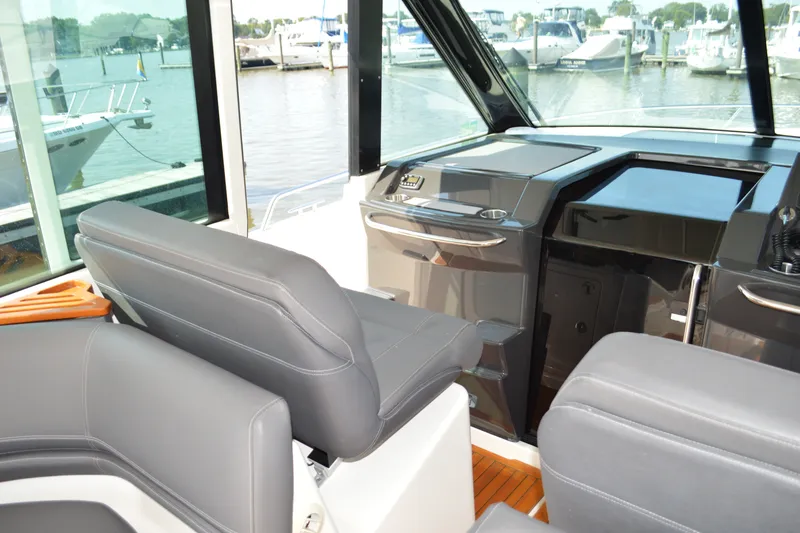 Slide: The Image of Interior view of 2016 Tiara Yachts Q44, featuring sleek seating and modern dashboard. - 56