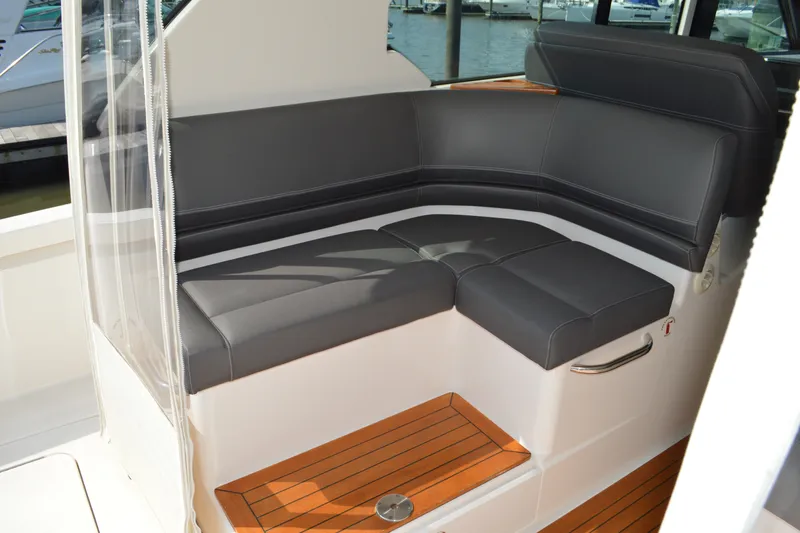 Slide: The Image of Luxurious seating area on 2016 Tiara Yachts Q44 with sleek black cushions. - 45