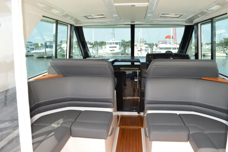 Slide: The Image of Interior of 2016 Tiara Yachts Q44 with sleek seating and panoramic windows. - 43