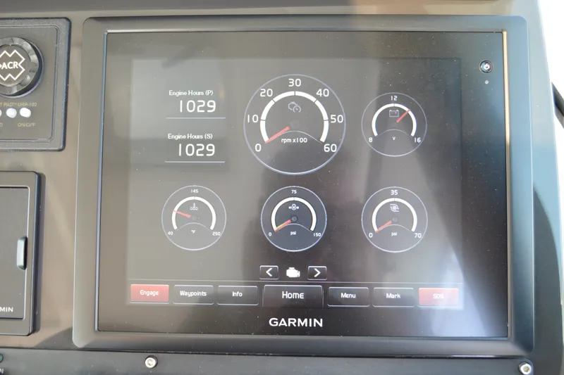 Slide: The Image of Garmin display on 2016 Tiara Yachts Q44 showing engine hours and gauges. - 80