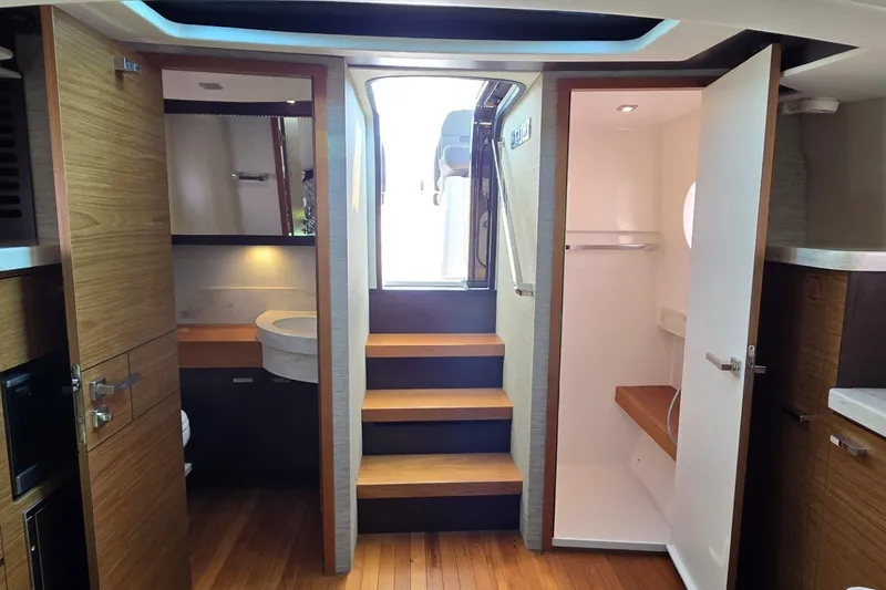 Slide: The Image of Interior of 2016 Tiara Yachts Q44, featuring wooden cabinetry and modern design elements. - 65