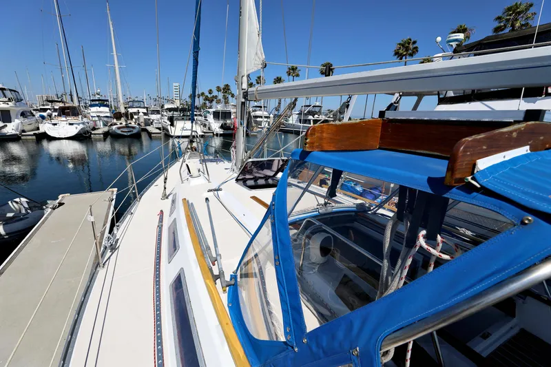 Slide: The Image of Jeanneau Sun Magic 44 sailboat docked in marina, 1990 model, with blue canopy. - 28