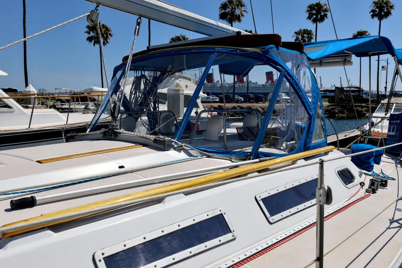 Slide: The Image of Jeanneau Sun Magic 44 sailboat docked, 1990 model, with blue canopy and clear panels. - 32