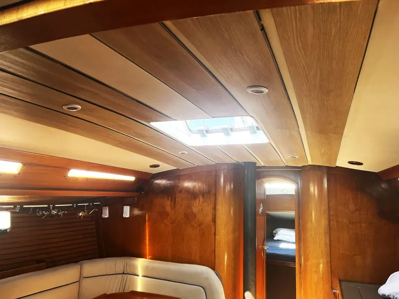 Slide: The Image of Interior of 1990 Jeanneau Sun Magic 44 yacht with wooden finish and skylight. - 6
