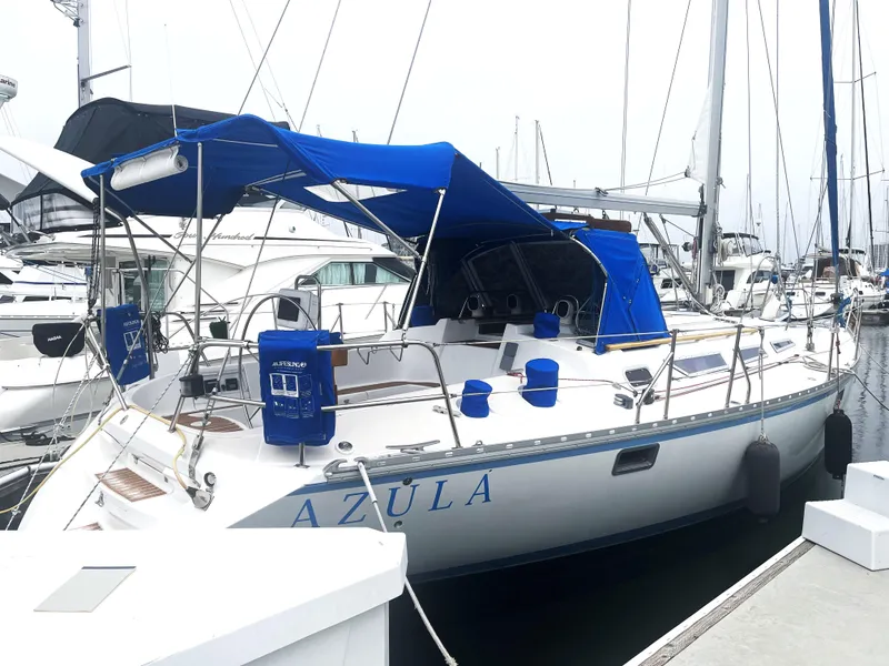 Slide: The Image of Jeanneau Sun Magic 44 sailboat, 1990 model, docked with blue canopy and accessories. - 0