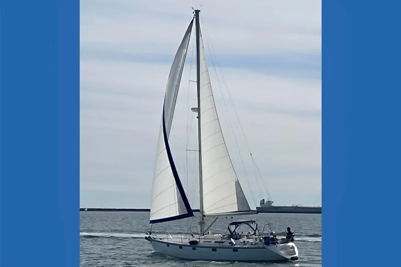 The Image of 1990 Jeanneau Sun Magic 44 sailboat cruising on open water with full sails. - 1