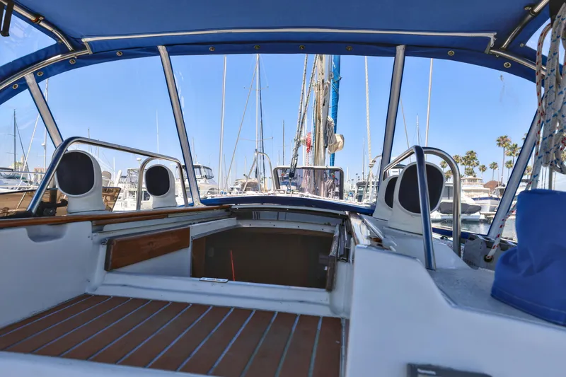 Slide: The Image of Cockpit view of 1990 Jeanneau Sun Magic 44 sailboat in marina, blue canopy overhead. - 22