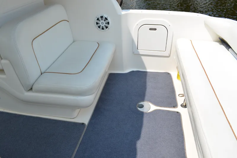 Slide: The Image of Interior seating area of a 1998 Sea Ray 290 Sundancer boat with white upholstery. - 24