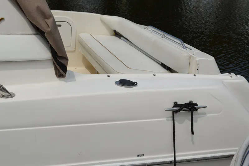 Slide: The Image of 1998 Sea Ray 290 Sundancer boat deck with seating and mooring cleat. - 16