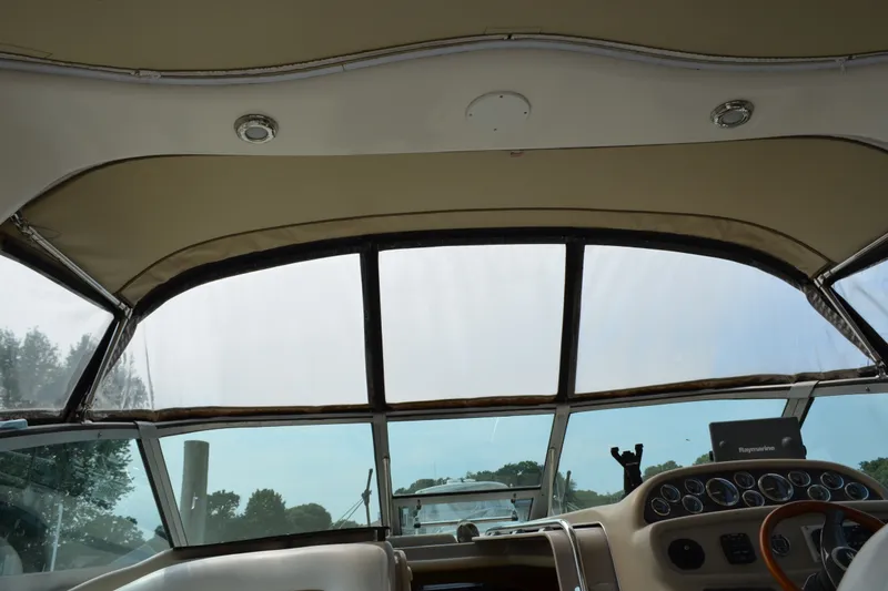 Slide: The Image of Interior view of 1998 Sea Ray 290 Sundancer boat cockpit with steering wheel and dashboard. - 31