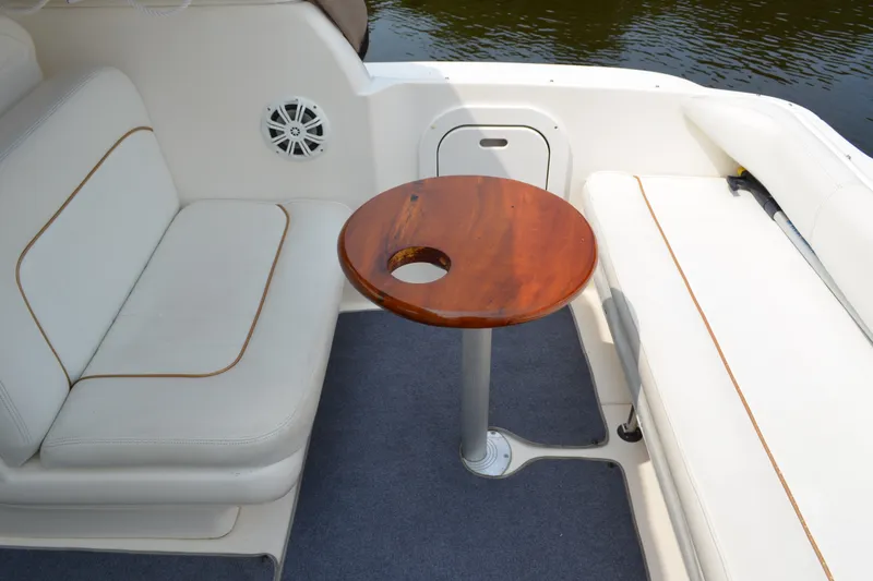 Slide: The Image of Interior of 1998 Sea Ray 290 Sundancer boat with seating and wooden table. - 27