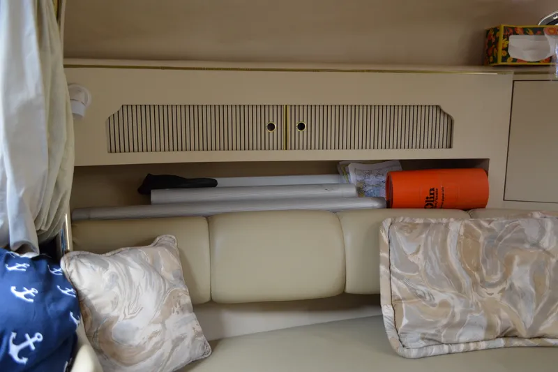 Slide: The Image of Interior of 1998 Sea Ray 290 Sundancer with storage and cushions. - 45