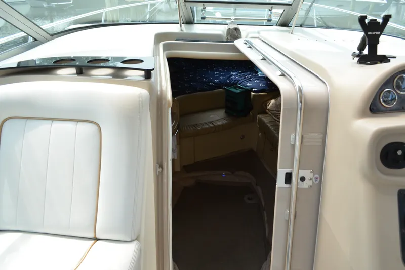 Slide: The Image of 1998 Sea Ray 290 Sundancer cabin interior with seating and dashboard view. - 38