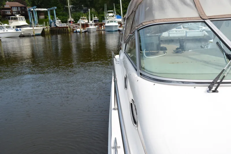 Slide: The Image of 1998 Sea Ray 290 Sundancer docked at a marina with other boats. - 15