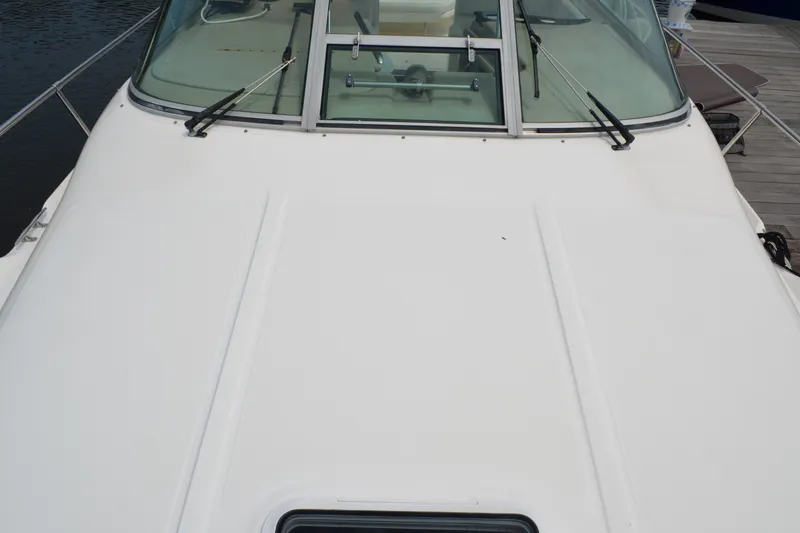 Slide: The Image of 1998 Sea Ray 290 Sundancer boat deck with windshield and wipers. - 13