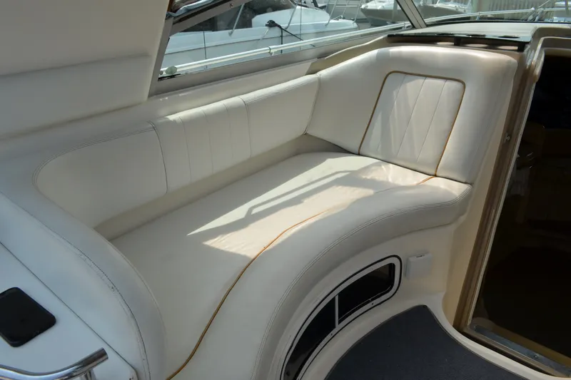 Slide: The Image of 1998 Sea Ray 290 Sundancer interior with white leather seating and elegant design. - 30