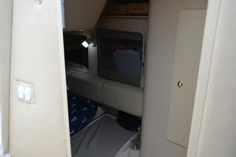 Slide: The Image of Interior cabin of 1998 Sea Ray 290 Sundancer boat, featuring cozy seating and ambient lighting. - 54