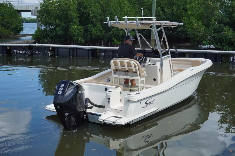 Slide: The Image of 2022 Scout 215 XSF boat with Mercury 200 engine on calm water. - 10