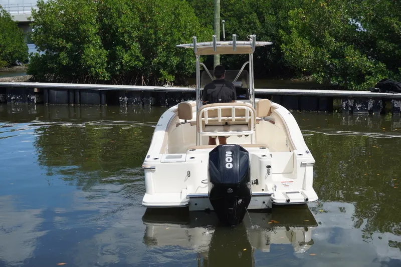 Slide: The Image of 2022 Scout 215 XSF boat with Mercury engine in a calm water setting. - 13