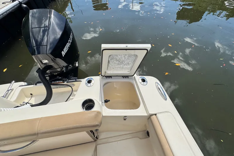 Slide: The Image of 2022 Scout 215 XSF boat with open storage compartment and Mercury engine. - 41