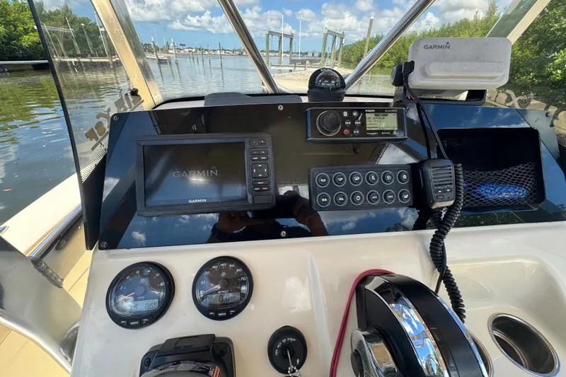 Slide: The Image of 2022 Scout 215 XSF boat dashboard with Garmin navigation system and controls. - 31