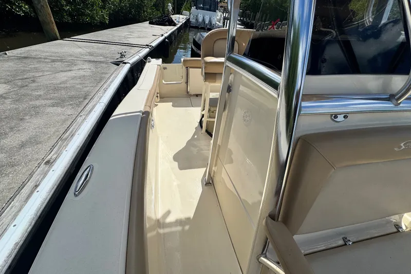 Slide: The Image of 2022 Scout 215 XSF boat docked, showcasing sleek interior and polished design. - 27