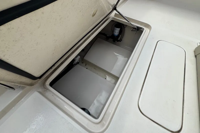 Slide: The Image of Open storage compartment on 2022 Scout 215 XSF boat deck. - 38