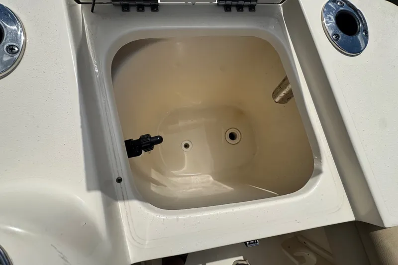Slide: The Image of Open storage compartment on 2022 Scout 215 XSF boat. - 40