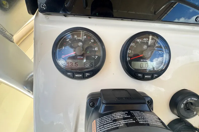 Slide: The Image of Dashboard of a 2022 Scout 215 XSF boat showing RPM and speed gauges. - 34