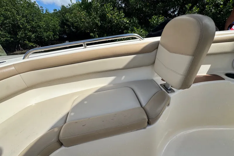 Slide: The Image of 2022 Scout 215 XSF boat interior with beige seating and stainless steel railing. - 16