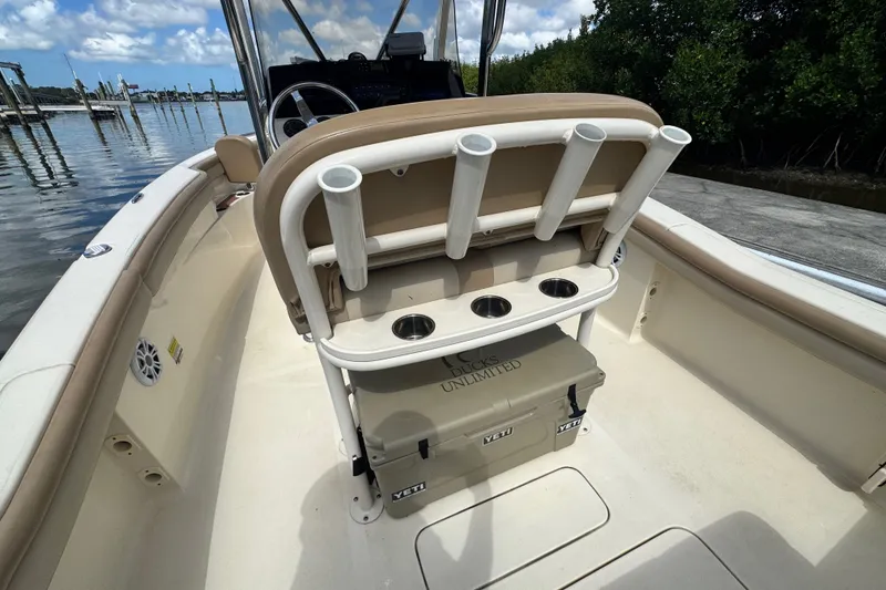 Slide: The Image of 2022 Scout 215 XSF boat interior with rod holders and Yeti cooler. - 42