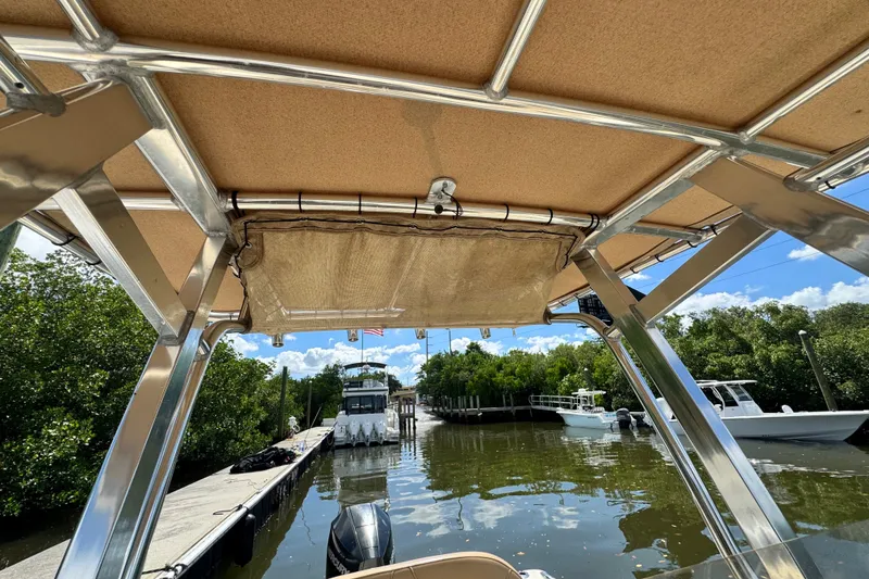 Slide: The Image of 2022 Scout 215 XSF boat interior view at a marina with clear skies. - 33