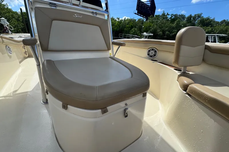Slide: The Image of 2022 Scout 215 XSF boat interior with cushioned seating and storage. - 20