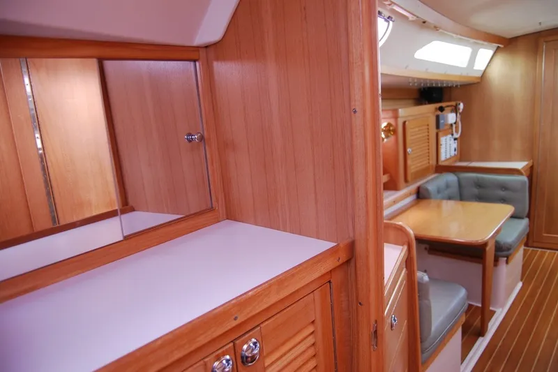 Slide: The Image of Interior of 2005 Catalina 36 MkII sailboat with wood paneling and cozy seating area. - 22