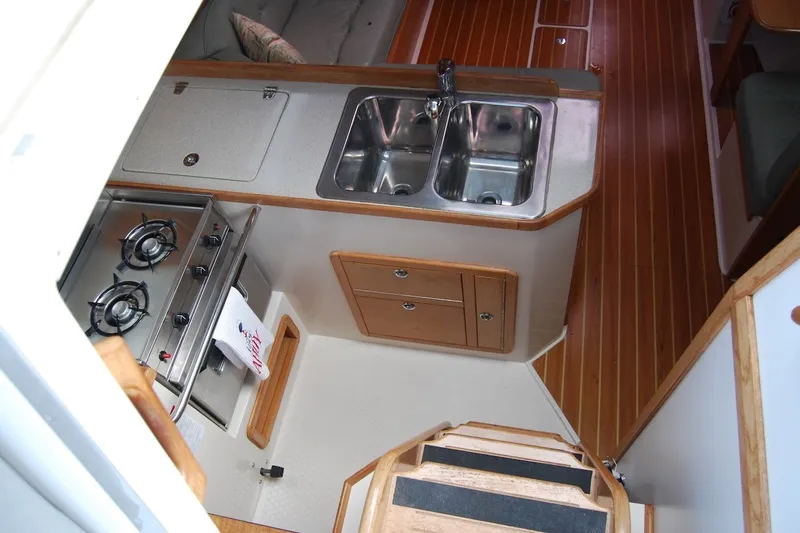 Slide: The Image of Interior of 2005 Catalina 36 MkII yacht with kitchen and wooden flooring. - 15