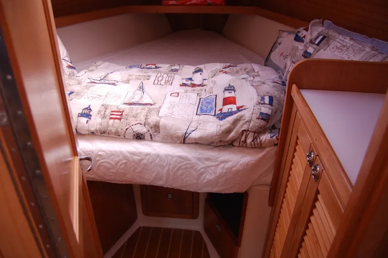 Slide: The Image of Cozy cabin interior of 2005 Catalina 36 MkII sailboat with nautical-themed bedding. - 21