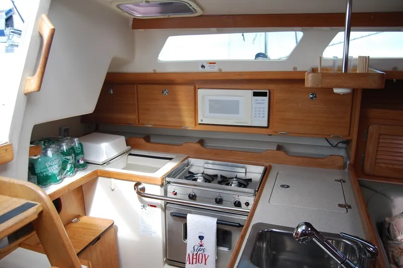 Slide: The Image of Interior of 2005 Catalina 36 MkII sailboat kitchen with stove, microwave, and sink. - 16