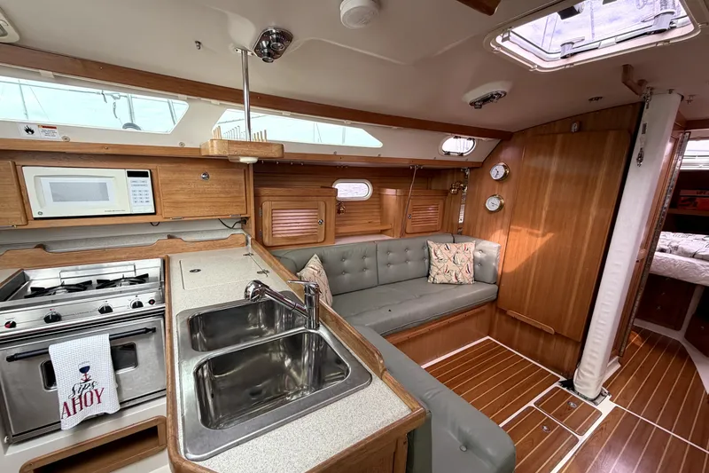 Slide: The Image of Interior of a 2005 Catalina 36 MkII sailboat with kitchen and seating area. - 5