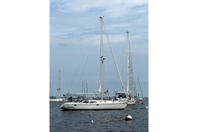 Slide: The Image of 2005 Catalina 36 MkII sailboat anchored in a calm harbor. - 0