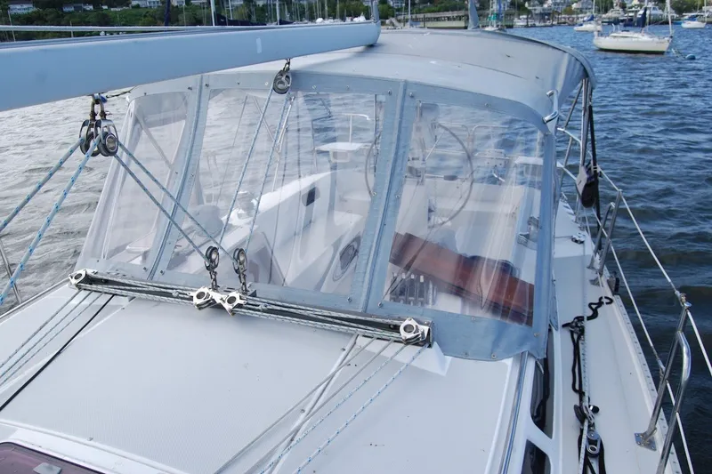 Slide: The Image of 2005 Catalina 36 MkII sailboat with clear cockpit enclosure on the water. - 14