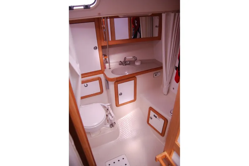 Slide: The Image of 2005 Catalina 36 MkII yacht bathroom with sink, toilet, and wooden cabinetry. - 20