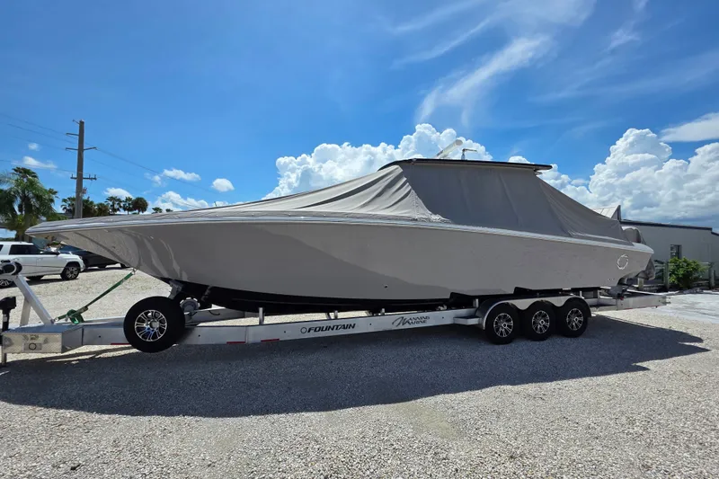 Slide: The Image of 2019 Fountain 38 Center Console boat on trailer under cover, sunny day. - 18