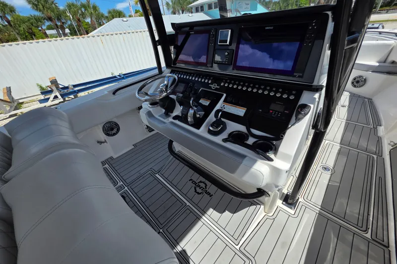 Slide: The Image of 2019 Fountain 38 Center Console boat interior with advanced navigation controls and seating. - 14
