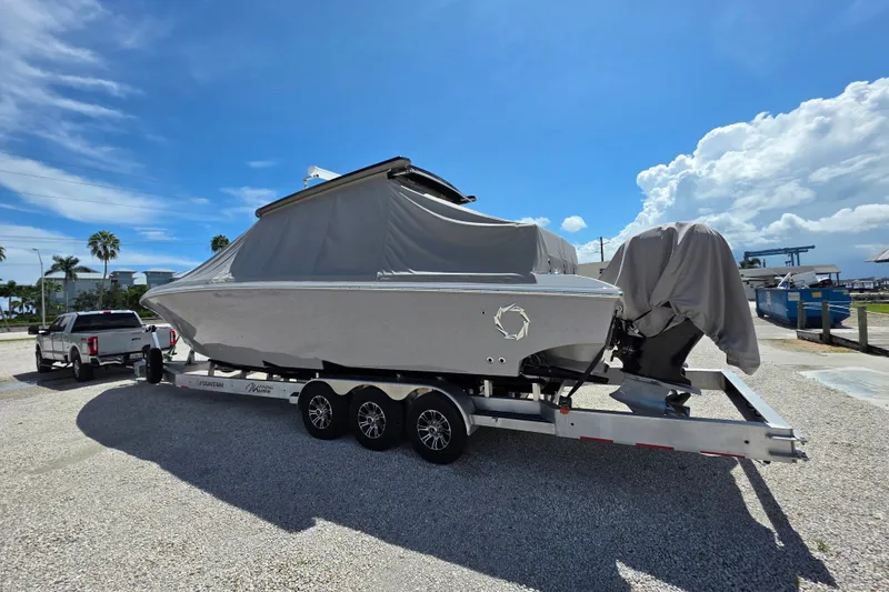 Slide: The Image of 2019 Fountain 38 Center Console boat on trailer, covered, sunny day. - 19