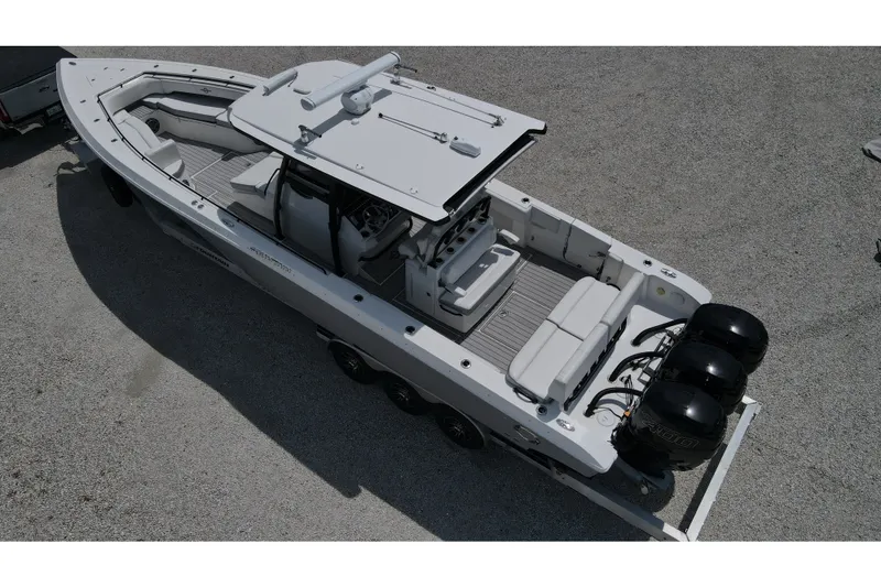 Slide: The Image of 2019 Fountain 38 Center Console boat with triple outboard engines on a trailer. - 21