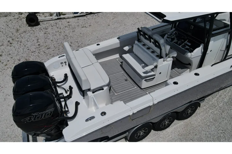 Slide: The Image of 2019 Fountain 38 Center Console boat with triple outboard engines, spacious seating, and modern controls. - 22