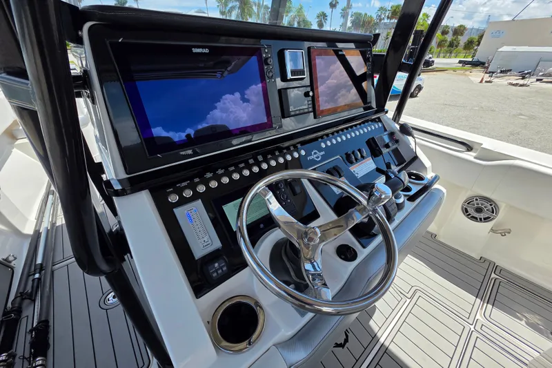 Slide: The Image of 2019 Fountain 38 Center Console boat dashboard with advanced navigation displays and controls. - 13