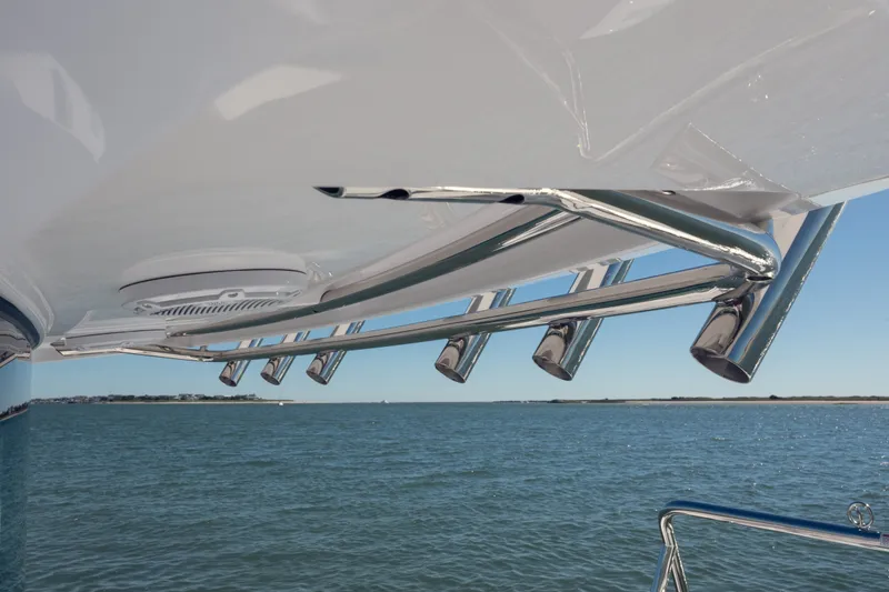 Slide: The Image of 2027 Axopar 29 XC Cross Cabin boat with stainless steel rod holders, ocean view. - 10